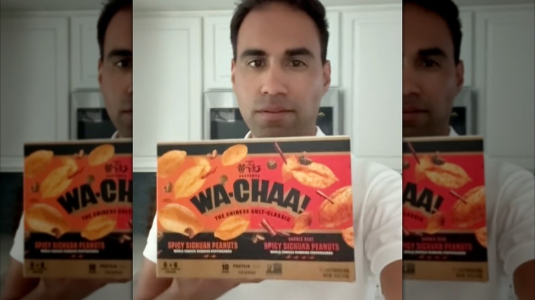 David of Costcocorner holding Wa-chaa! spicy peanuts at home