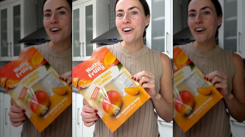 Kelsey Oppenheim of Costcofood reviews holds bag of Thai Mango Gummies