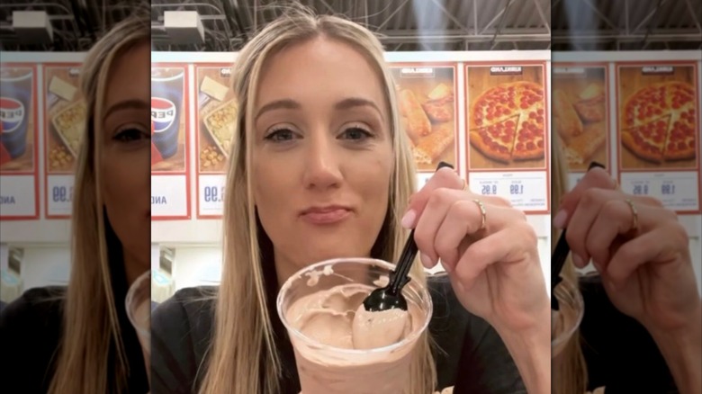 Costcohotfinds influencer Laura Lamb in Costco food court with milkshake and spoon
