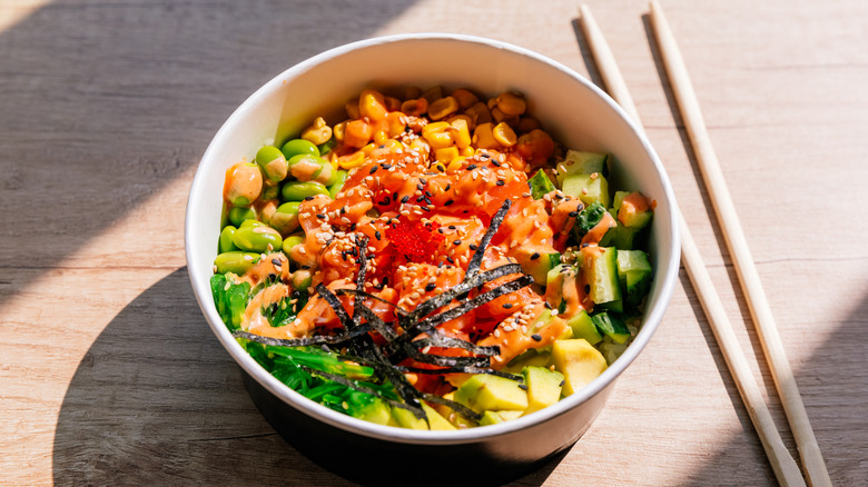 A poke bowl with chopsticks.