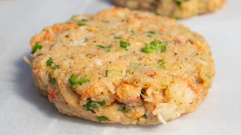 Uncooked crab cakes on parchment paper
