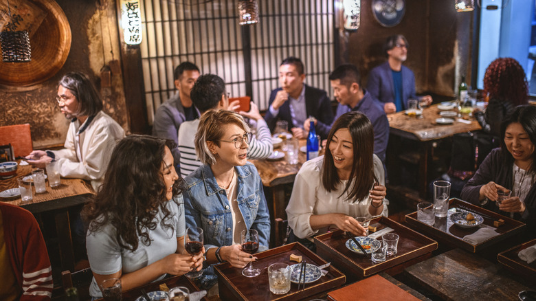 Diners enjoying their meals in small restaurant