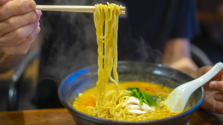 Lifting ramen from bowl