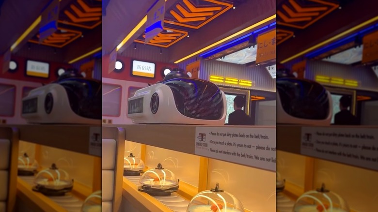 Sushi conveyor belt and futuristic, train station inspired interior