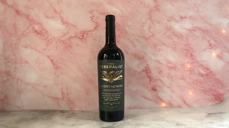 Bottle of The Federalist Bourbon Barrel Aged red wine on pink background
