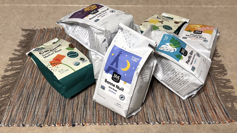 A variety of 365 Whole Foods coffee in bags on a neutral countertop