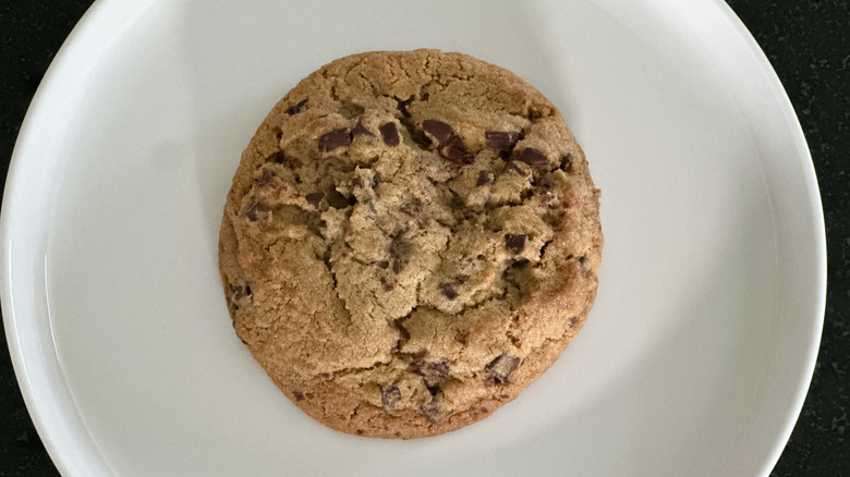 Overhead image of white plate with brown butter chocolate chip cookie