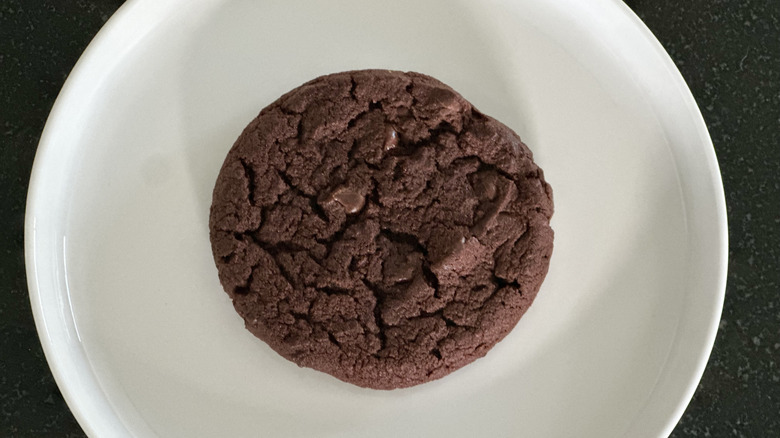 Overhead image of white plate with double chocolate cookie