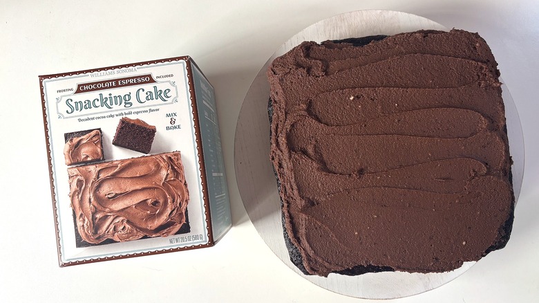 Box of Williams Sonoma Chocolate Espresso snacking cake mix next to chocolate espresso cake on white table