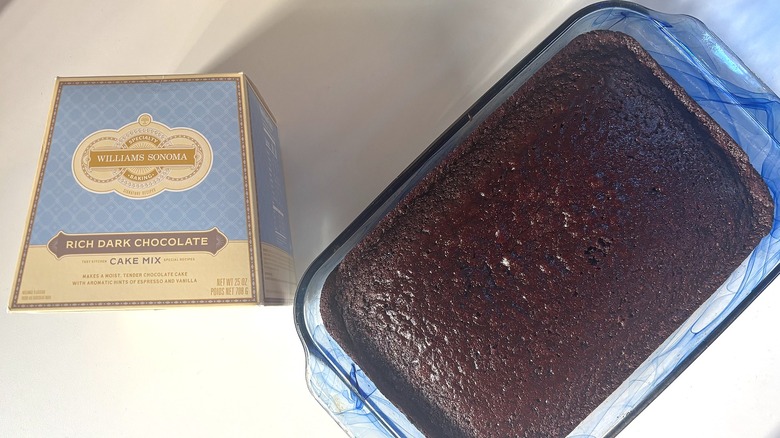 Box of Williams Sonoma Rich Dark Chocolate cake mix next to chocolate cake on white table