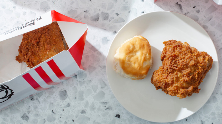Fried chicken breast and bun on plate from KFC