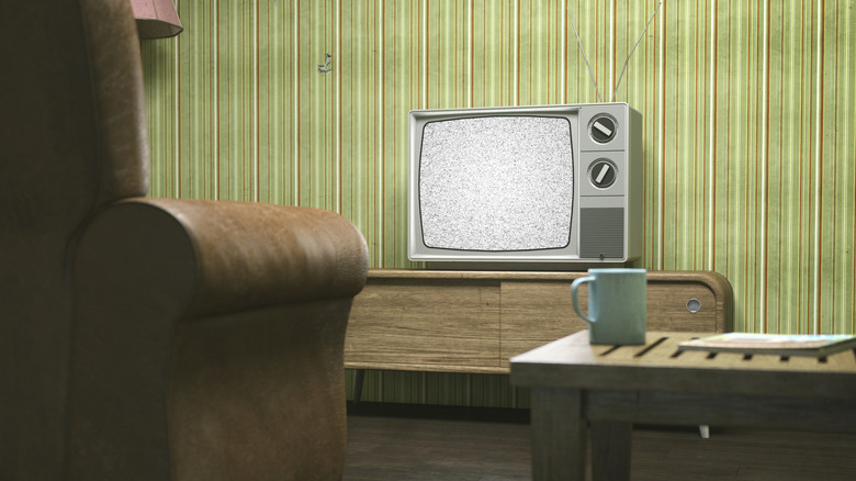 Old television set against a retro wallpaper