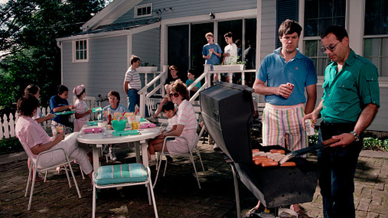 People on a patio during a 1970s cookout