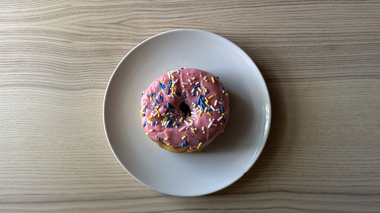 7-Eleven sprinkilicious donut on white plate