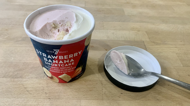 opened Strawberry Banana Shortcake pint with spoonful of ice cream next to it