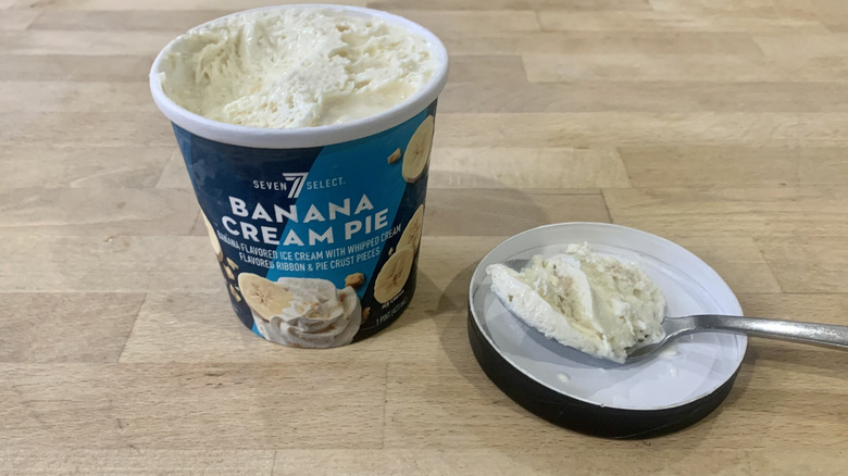 opened Banana Cream Pie pint with spoonful of ice cream next to it