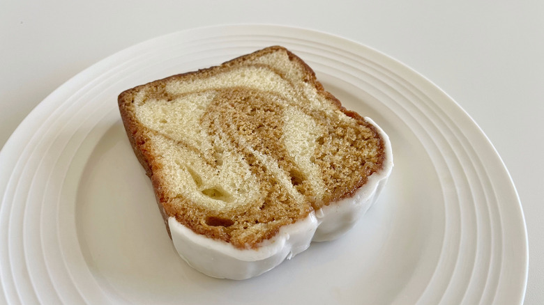 Slice of Dunkin' Iced Pumpkin Loaf on a white plate