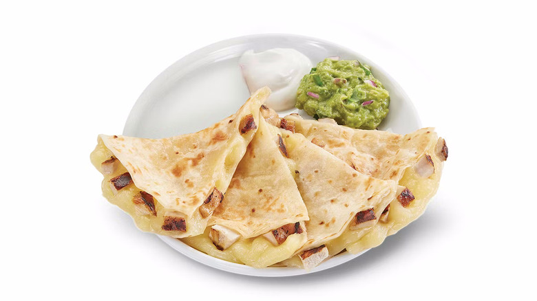 Baja Fresh chicken and cheese quesadilla on a plate with sour cream and guacamole