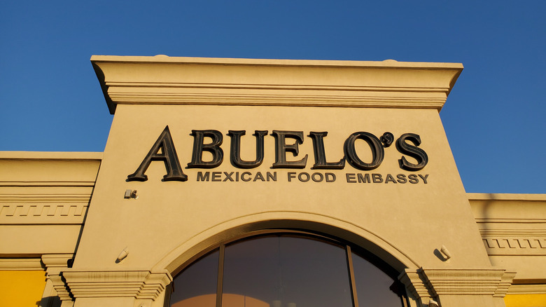 Sign for ABUELO'S MEXICAN FOOD EMBASSY beneath Blue Sky