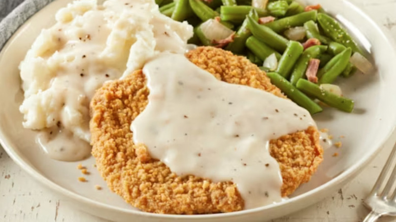 Bob Evans country fried steak meal with mashed potatoes and green beans.