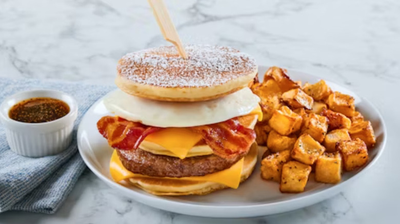 Bob Evans griddle stacker with honey sauce and seasoned potatoes.