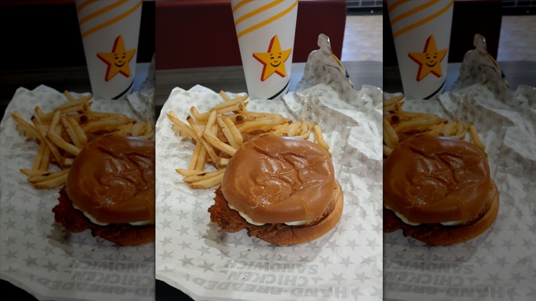 Hardee's Nashville Hot Hand-Breaded Chicken Sandwich with fries on wrapper