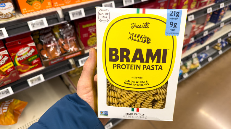 person holding brami protein pasta box