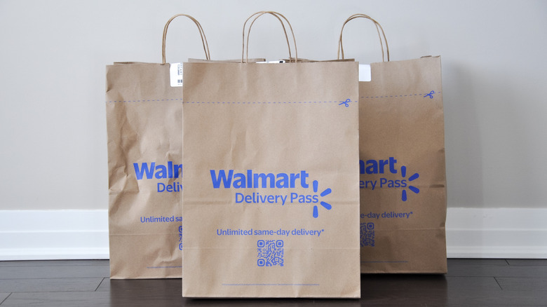 three walmart paper bags on floor