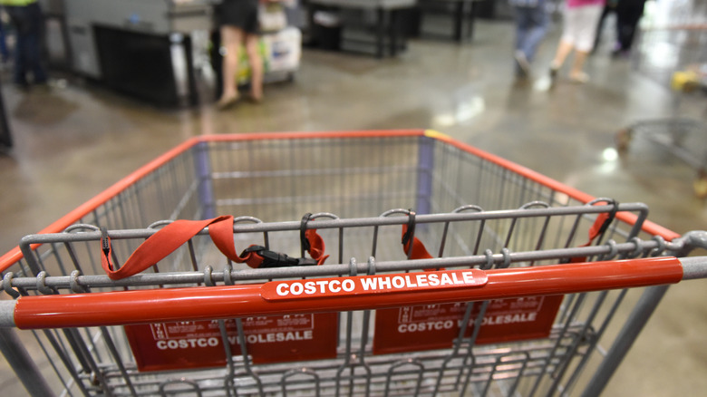 Close up of a cart at Costco with people in the background