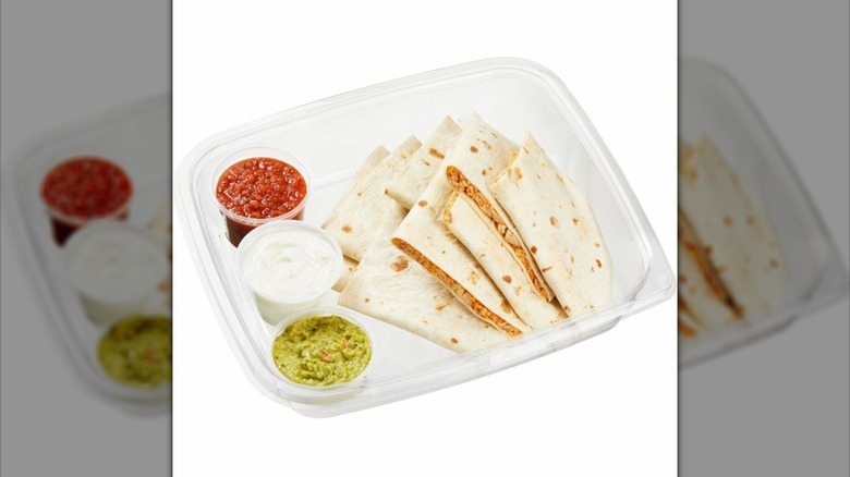 Kirkland Signature chicken quesadillas in plastic tray with various dips
