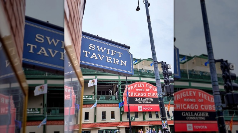 The exterior sign for Swift Tavern being photographed to show its proximity to the Wrigley Field marquee