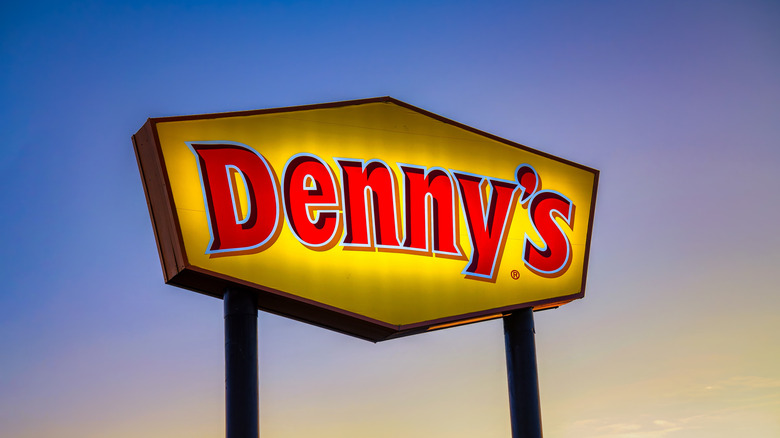 Denny's sign against a sunset