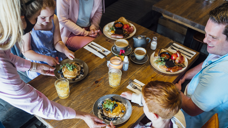 family getting served at restaurant