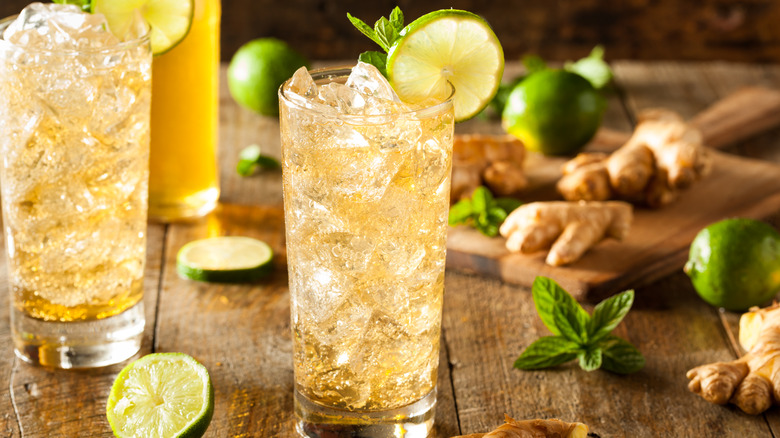 Two ginger sodas with fresh ginger and lime