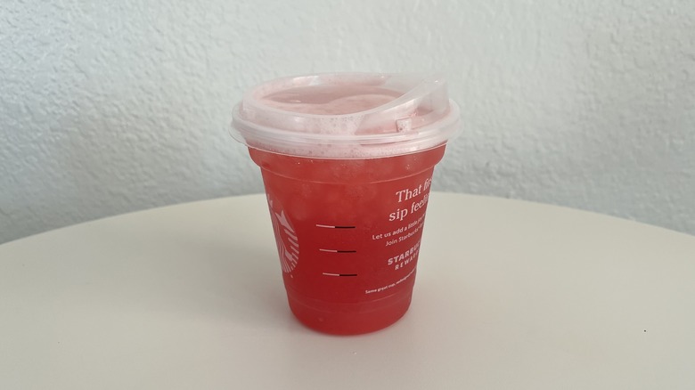 Cup Iced Passion Tango Tea Lemonade on white table