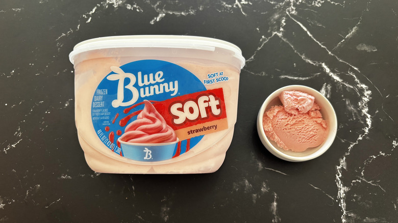 Blue Bunny strawberry ice cream tub next to small bowl of ice cream