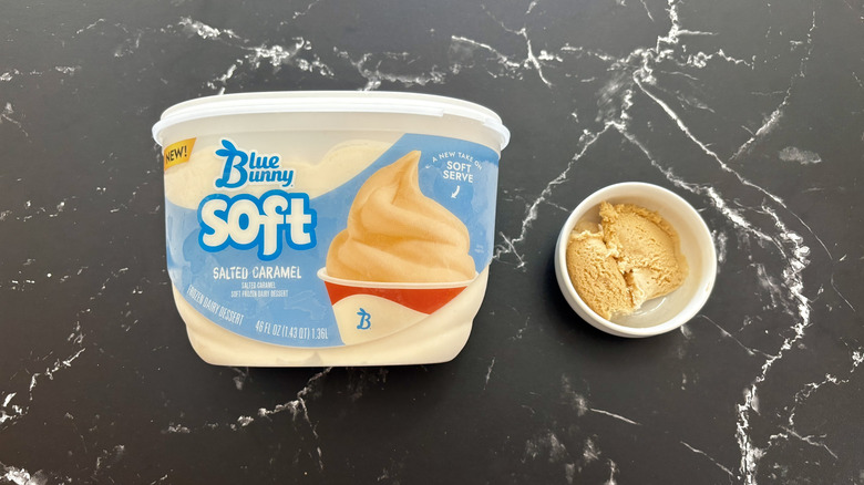 Blue Bunny salted caramel ice cream tub next to small bowl of ice cream