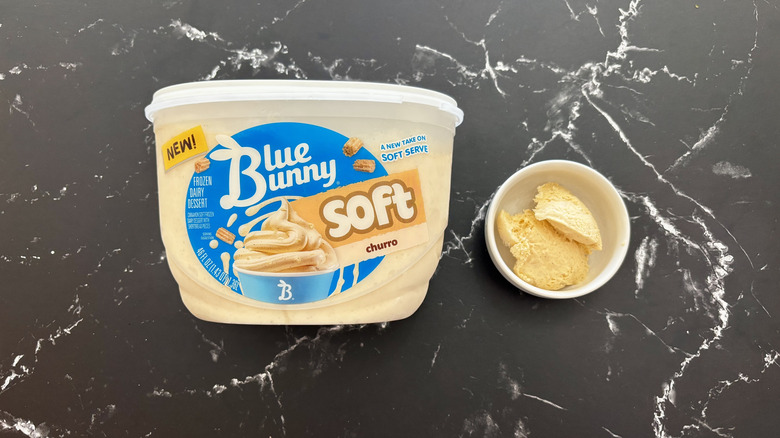 Blue Bunny churro ice cream container next to ice cream in bowl