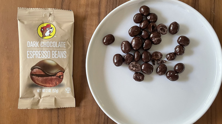 Dark chocolate espresso beans on a plate and with packaging