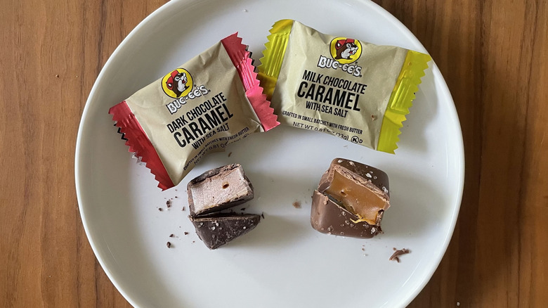 Two types of caramels on a plate with packaging