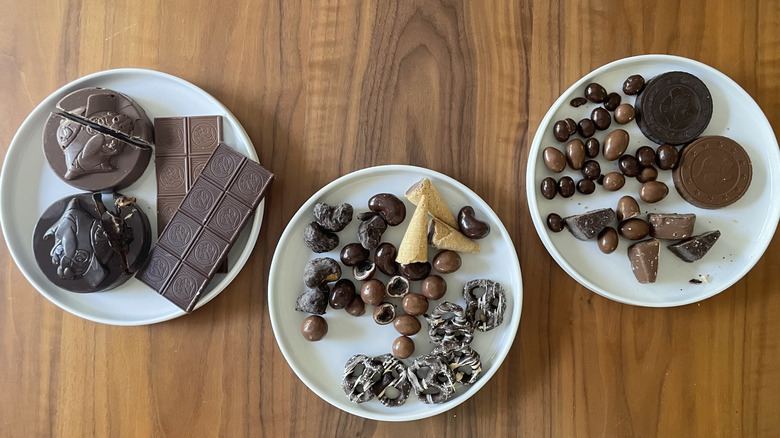 Assorted chocolate candies on three different plates