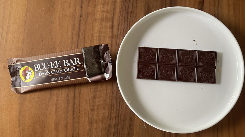Dark chocolate Buc-ee bar on a plate with packaging