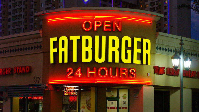Exterior sign for Fatburger chain location shot at night