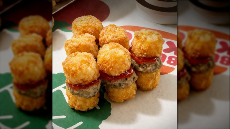 Mini hash brown sliders with sausage and ketchup