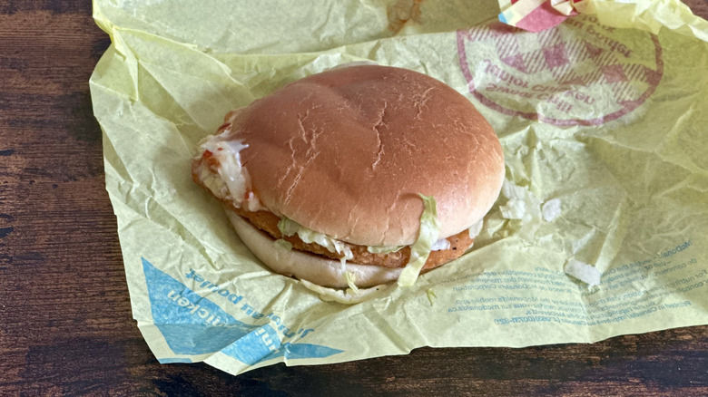 Yellow wrapper with small chicken sandwich from McDonald's