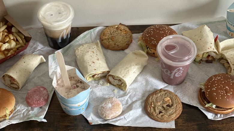 Overhead image of assorted McDonald's items on wooden console table in front of light colored wall