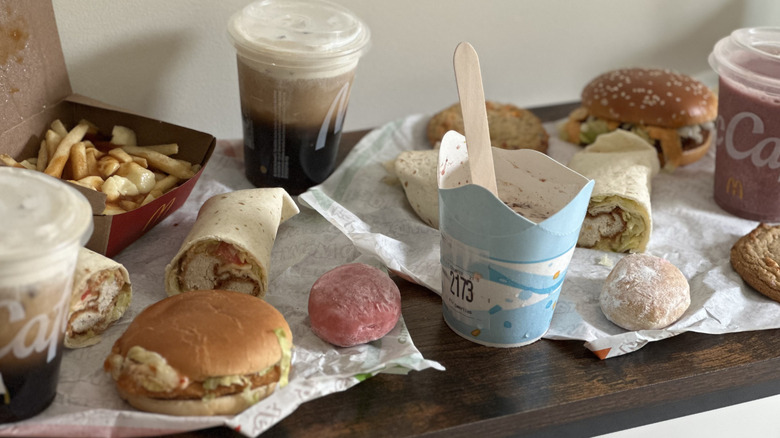 Assorted McDonald's items on wooden console table in front of light colored wall