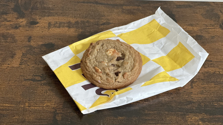 White and yellow bag with s'mores cookie on wooden table