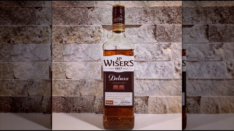 J.P. Wiser's Deluxe bottle of whisky on table.