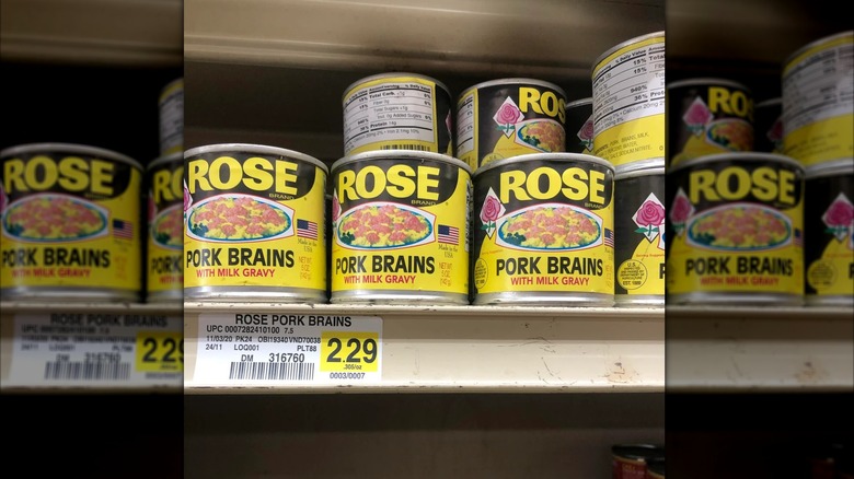 cans of Rose Pork brains on store shelf, mirrored image